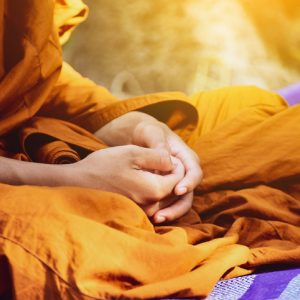 Buddhist monk with hands in lap