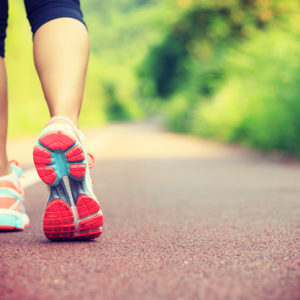 A woman walks in exercise gear.