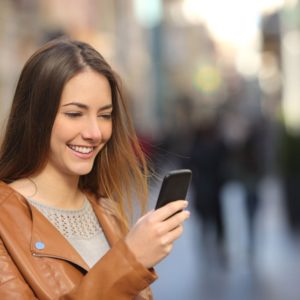 woman happy looking at phone