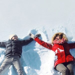 Mother and sun playing in snow