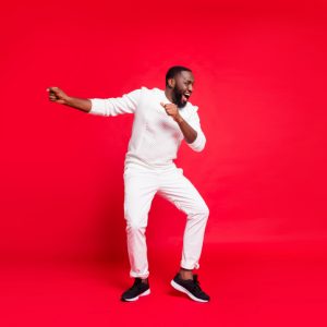 man dancing on red background