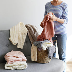 Woman sorting her sweaters