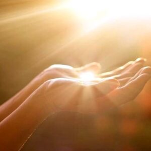 woman's hands holding light