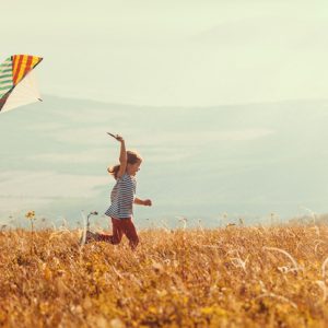 little girl flying kite as ecotherapy