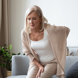 Woman in her 60s suffers from chronic back pain.