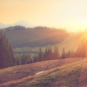 Sun breaks over a beautiful mountain scene