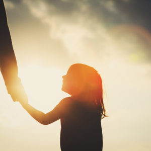 daughter holding dad's hand