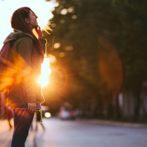 young woman staring up at sky contemplating spirituality and intuition