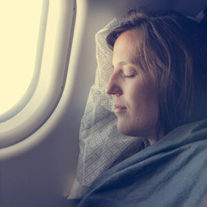 woman sleeping on plane