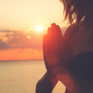 Silhouette of woman's hands in prayer