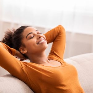 woman relaxed on couch lessen fear