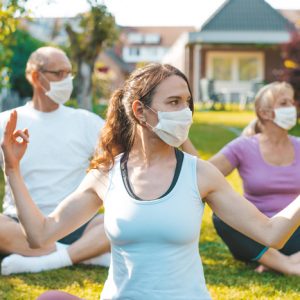 masked retreat goers do yoga