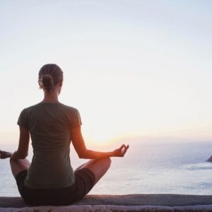 Woman in meditatoin on seaside