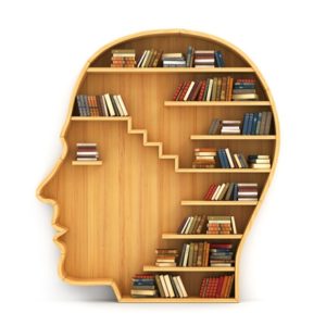 books on wooden head-shaped bookshelf