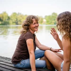 Two women talking on a dock