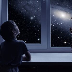 Child looking out dark window