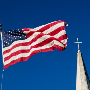 American flag flying in front of church