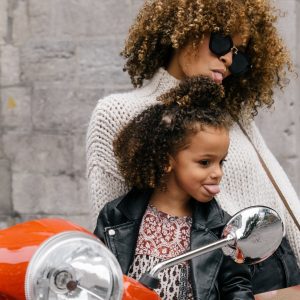 Woman and girl stick their tongues out not taking themselves too seriously