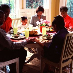 Family praying together at table
