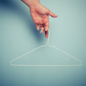 Person holding clothes hanger