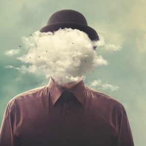 Surreal man with bowler hat with face hidden in clouds