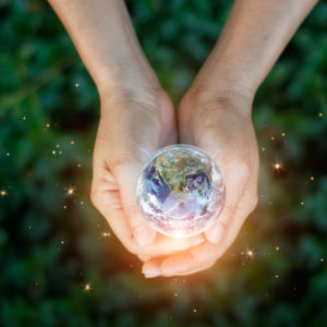 Woman holding glowing globe