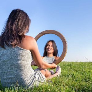 Woman looking in mirror