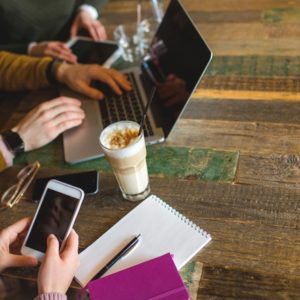 cellphones and computer at coffee shop