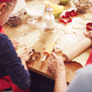 Grandma making cookies with granddaughter