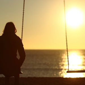 Woman watching sunset for solace