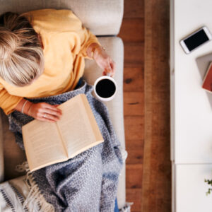 woman reading with a cup of coffee