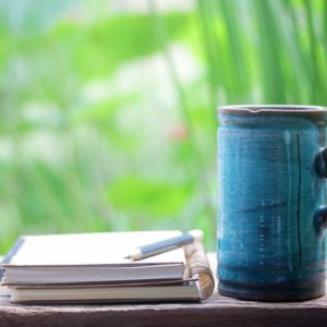 Notebook and coffee mug