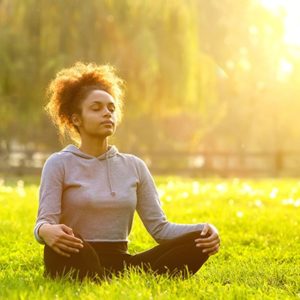 woman breathing in grass and sun