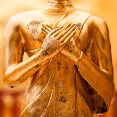 Buddha statue with hands on heart