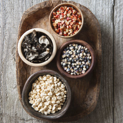 Platter of dried mushrooms and a variety of corn in small bowls