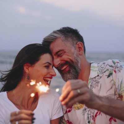 Mature couple playing with sparklers for Passion & Presence