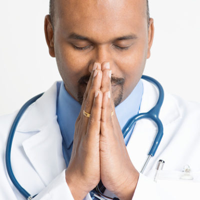 Indian doctor praying