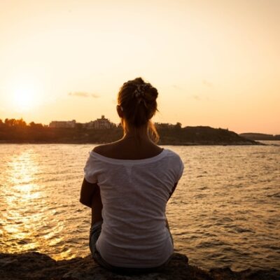 Woman staring at the water affirmations for grief