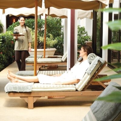 Woman in lounge chair at Halekulani Hotel