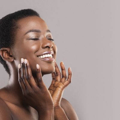 A woman massages her face as an embodiment practice