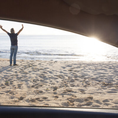 <img src="man-stretches-outside-car.jpg" alt="man on the beach stretches outside his car"/>