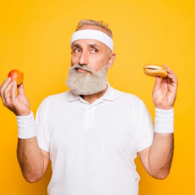 Man holding up food wondering if the vegan recipe will taste like the real thing.