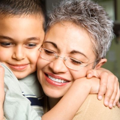 Grandma hugging grandson and smiling