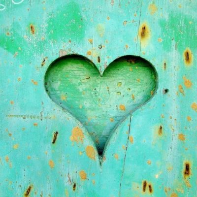 Heart carved into teal aged wood