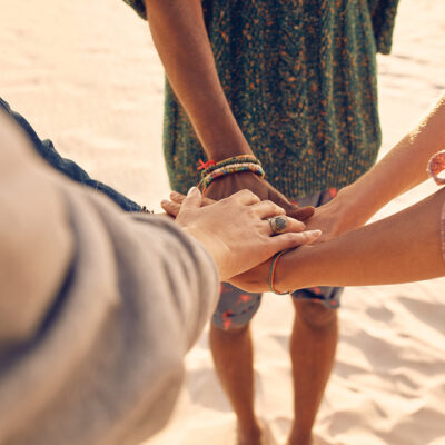 Hands together on beach