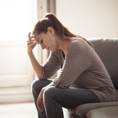 upset woman on couch