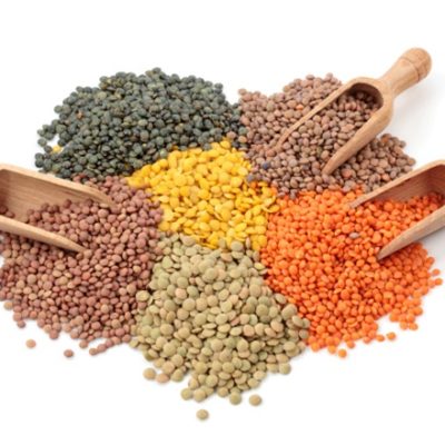 Variety of lentils and wooden spoons