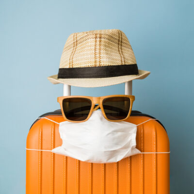 suitcase with sunglasses, mask, and hat