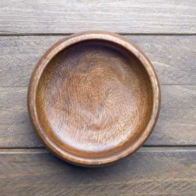A simple wooden bowl illustrates how containers matter as much as what goes in them
