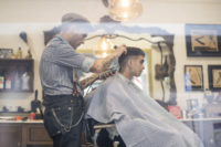 man getting haircut at barber shop